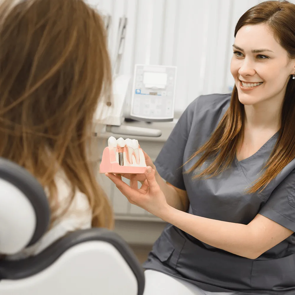 Dentist showing dental implants