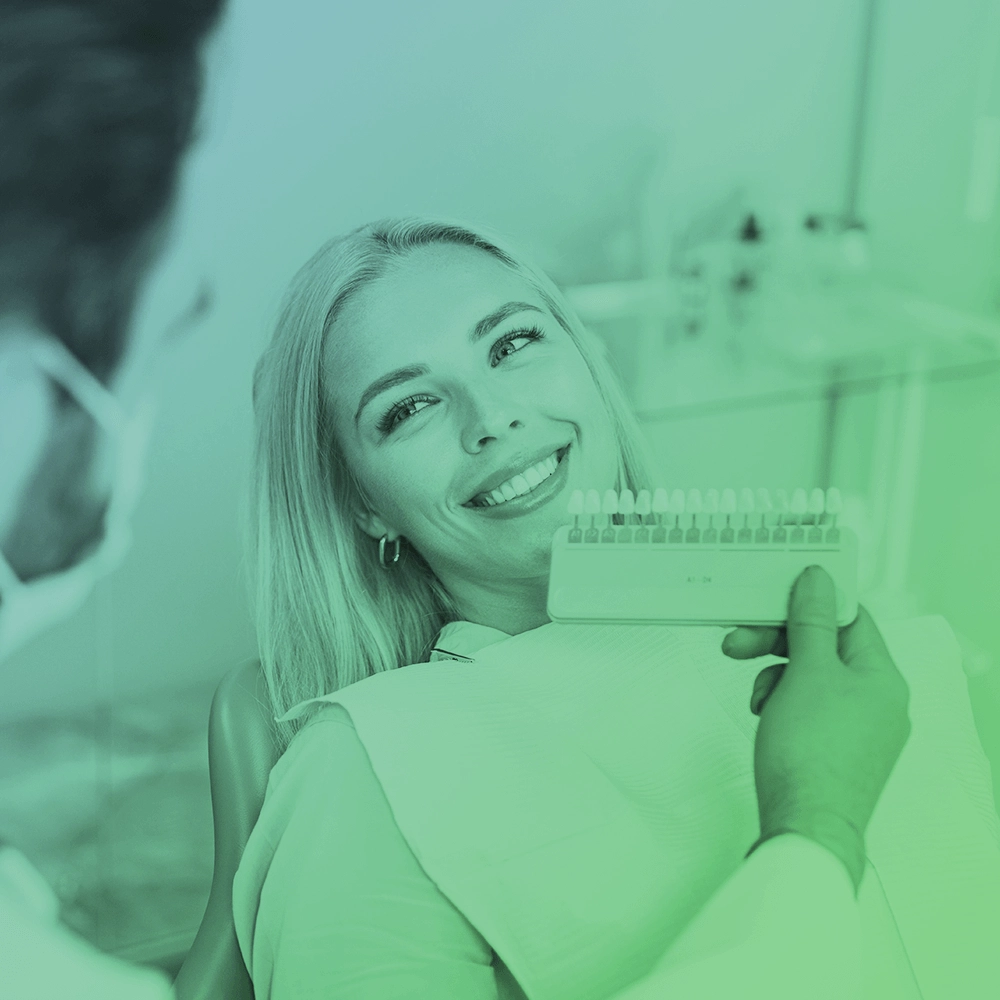 Dentist showing veneers to patient