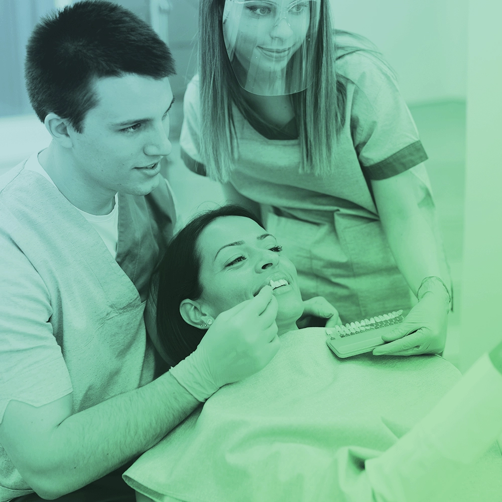 Dentist showing veneers to patient