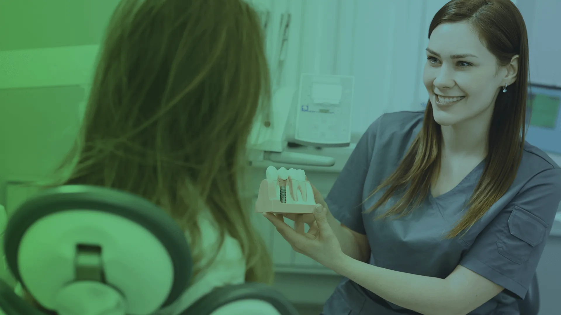 Dentist showing dental implants