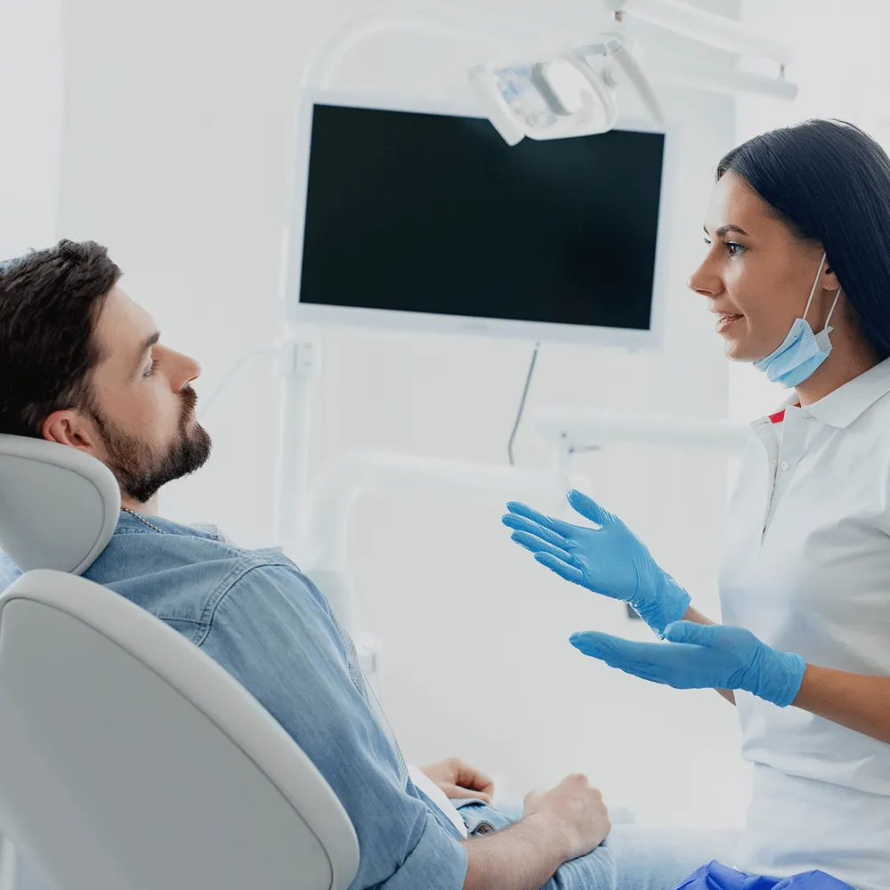 Dentist talking to patient