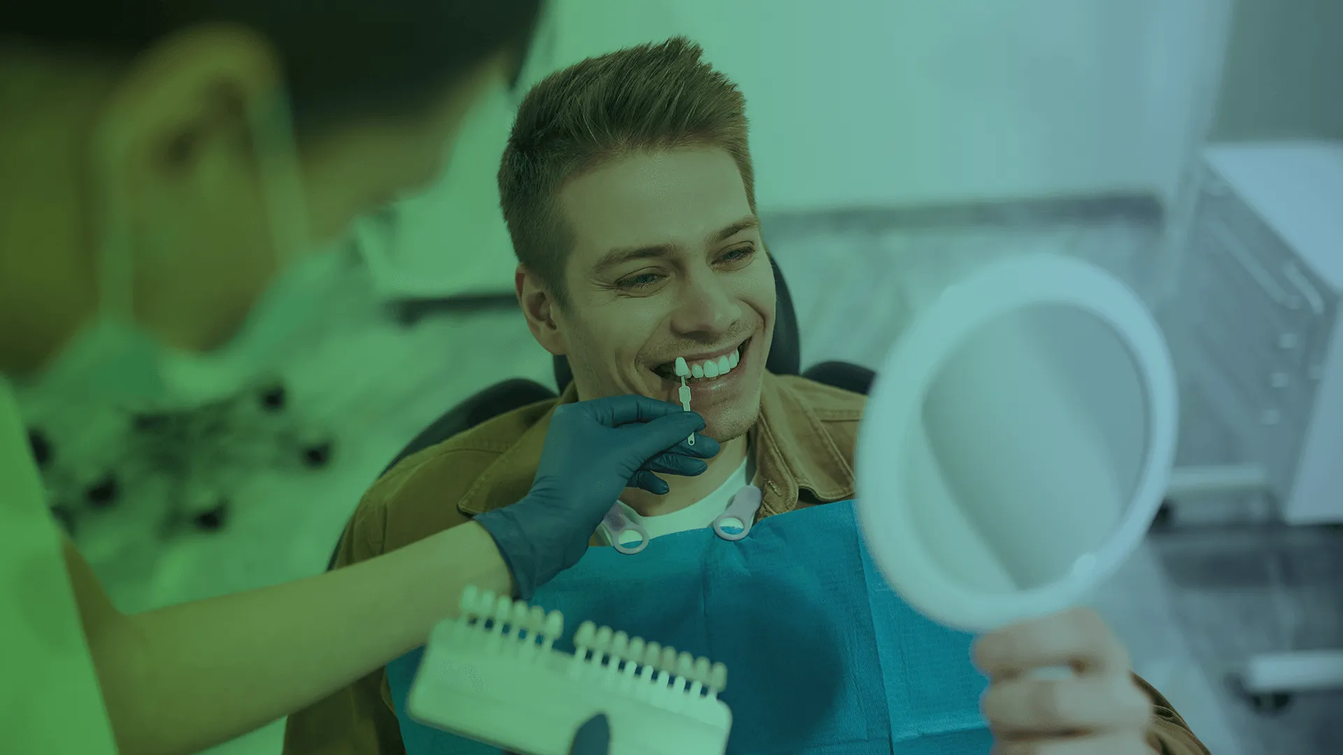 Dentist looking in mirror with veneers held by dentist